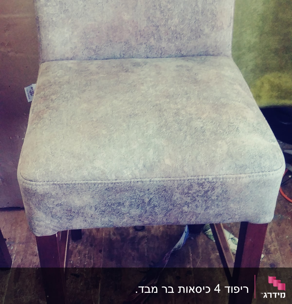 כיסא מרופד עם רגלי עץ על רצפת עץ